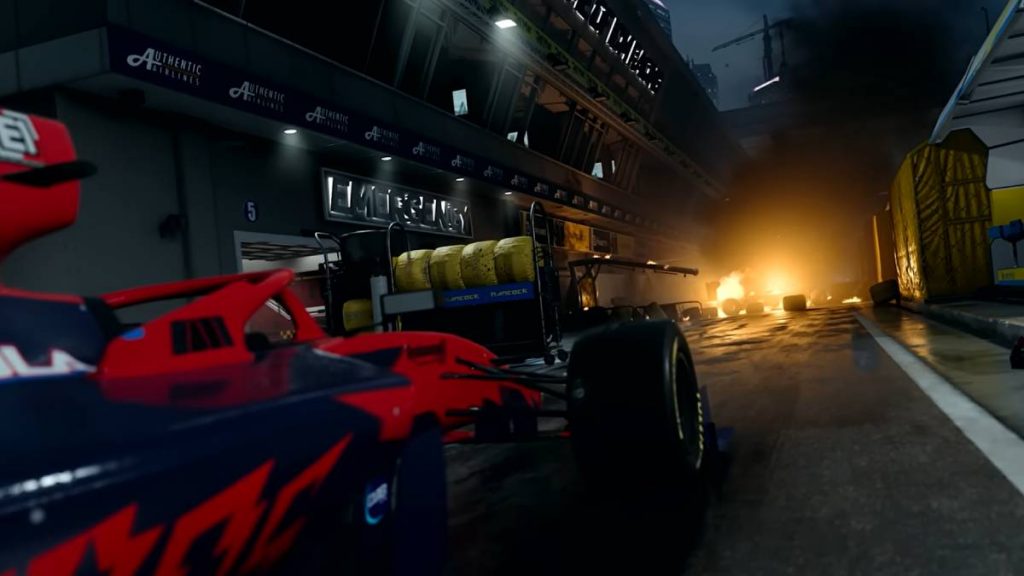 a red and black race car on an abandoned racetrack in the map Grand Prix from MW2 with a large building with the word "Emergency" on it to the left