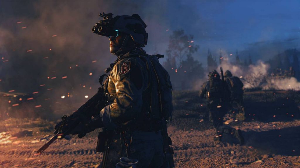 a shot of a soldier wearing night-vision goggles and holding an assault rifle standing in the dark as two soldiers limp away in the distance
