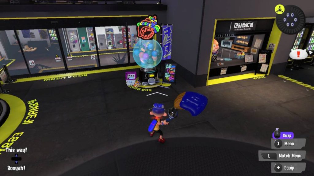 an inkling standing in front of the Shell-Out machine from Splatoon 3 in the Splatsville area