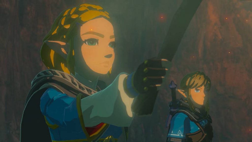 Link and Zelda from The Legend of Zelda: Tears of the Kingdom standing in a cave with Zelda holding a torch