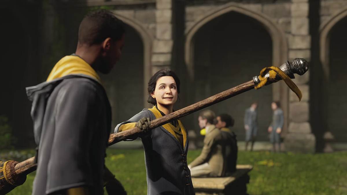 a student holding up a broom in Hogwarts Legacy