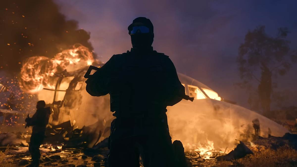 Soldier standing guard next to a crashed plane on fire in MW3